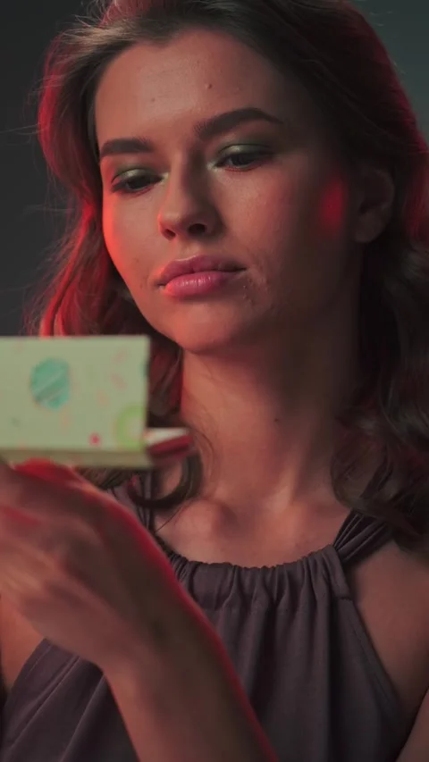 Young cute female model with long hair looking at makeup set Stock Footage 307901273