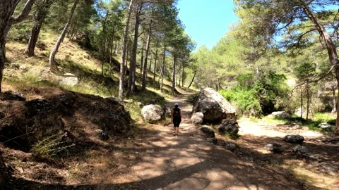 Young cute girl walking down the stream of Guazalamenco river. Stock Footage 135217236