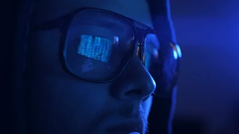 Young cyberpunk student hacker typing on the computed under the blue neon light. Stock Footage 95283232