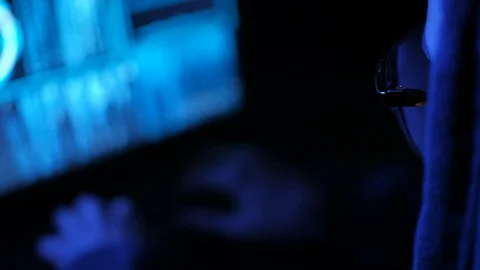 Young cyberpunk student hacker typing on the computed under the blue neon light. Stock Footage 95283962