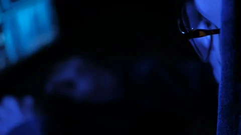 Young cyberpunk student hacker typing on the computed under the blue neon light. Stock Footage 95284302