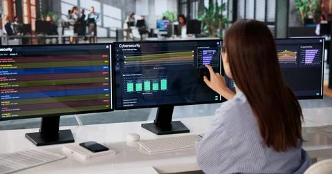 Young Cybersecurity Expert Monitors Multiple Screens Detecting Online Attack  Stock Photos