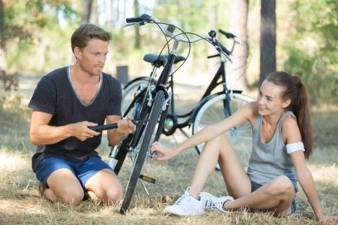 Young cyclists pumping up bicycle tyre Stock Photos