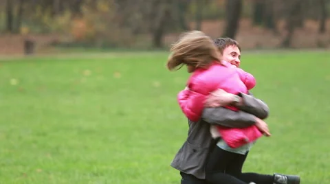 Young dad carries daughter and plays with her in park Stock Footage 59554539
