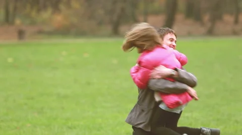 Young dad carries daughter and plays with her in park Stock Footage 59554542