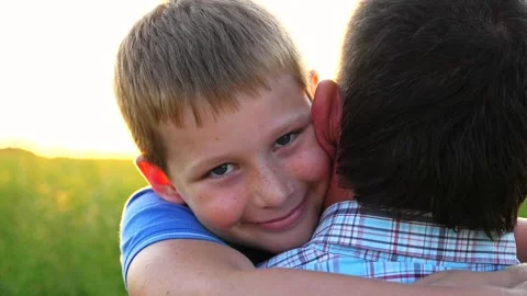 Young dad holding in hands his happy small son at countryside. Little smiling Видео 333999060