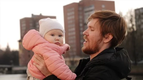 Young dad hugs and throws up little girl Stock Footage 130696227