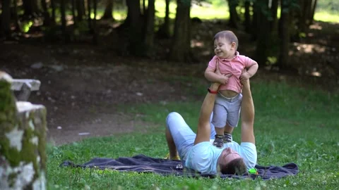 Young dad playing with his son on a picnic Stock Footage 144093764