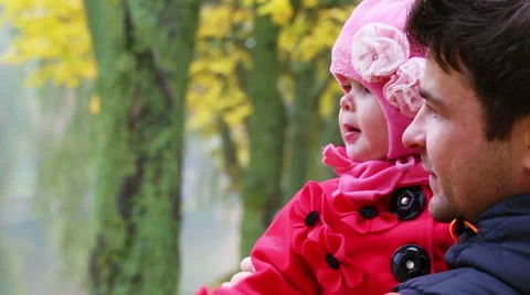Young Dad with a small child having fun in autumn park - closeup, handheld shot Stock Footage 56796947