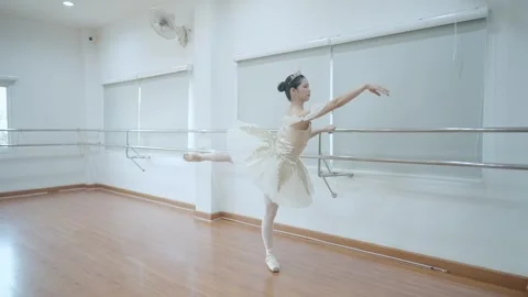 Young dancer in beautiful white tutu performs dance elements of classical ballet Stock Footage 280938558