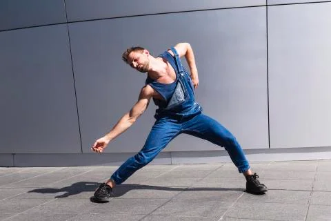 Young dancer doing dance motion on gray background Stock Photos