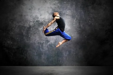 Young dancer is jumping on stage  Stock Photos
