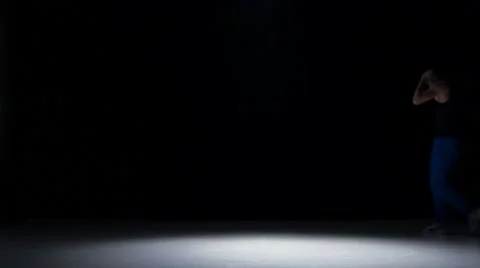 Young dancer man in cap dancing breakdance on black Stock Footage 61306810