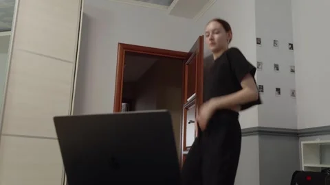 Young dancer practicing modern dance at home using laptop Stock Footage 307156551