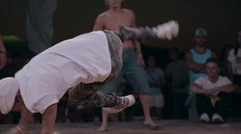 Young Dancer in White T-Shirt Performing the Elements of Break Dance on the Stock Footage 61471870