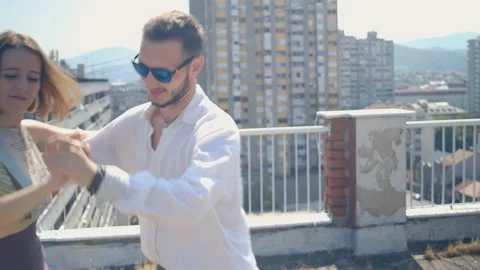Young dancing couple dance on the building rooftop Видео 159135149