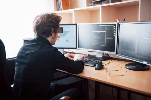 The young dangerous hacker breaks down government services by downloading s.. Stock Photos