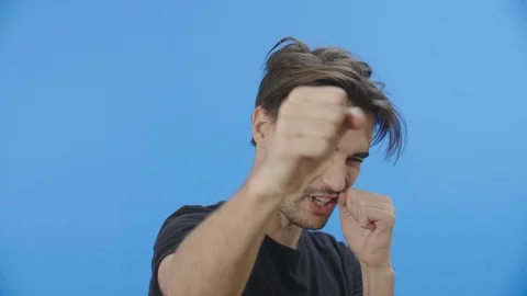 Young dark-haired man playfully punching Stock Footage 88399714