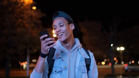 Young dark skinned guy sends and receives a voice message and smile Stock Footage 116158801