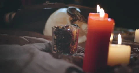 Young dark witch reading magic book looking for spell Stock Footage 136883502