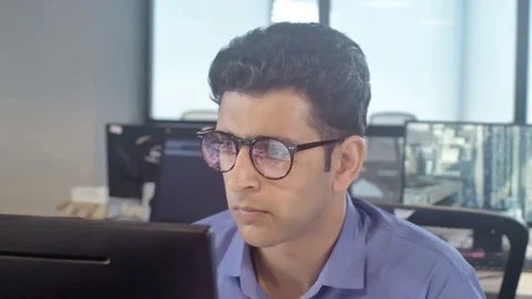Young dedicated and attractive office employee sitting in front of the computer Stock Footage 87179682