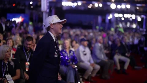 A young delegate stands and cheers on the convention floor, RNC Dallas 2026 Stock Footage 345271821