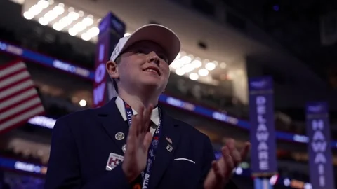 A young delegate in a white cap pumps his fist and cheers, RNC Dallas 2026 Stock Footage 345274872