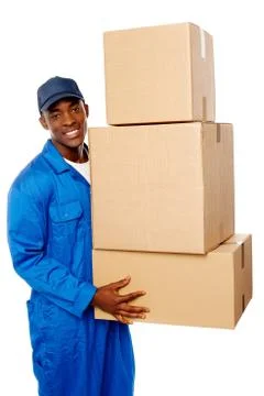 Young delivery guy holding stack of parcel boxes Foto stock