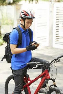 Young delivery man checking application in his phone Foto stock