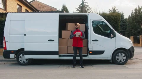 Young delivery man using tablet to find the address and deliver parcel 스톡 동영상 150647523