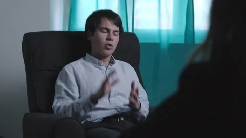 Young depressed man explains his problems to the psychologist Stock Footage 183423121