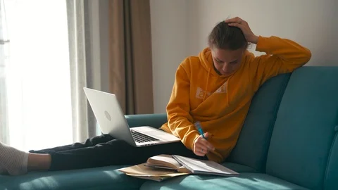 A young depressed student preparing for exams at home. Stock Footage 127565233
