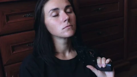 Young depressive woman trying to commit suicide with gun. The concept of social  Stock-Footage 200775114