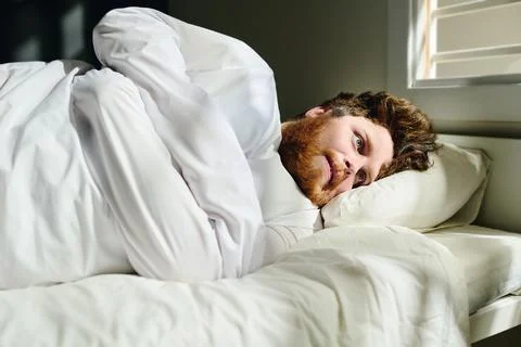 Young deranged man in straitjacket suffering from panic attack or psychosis Foto stock