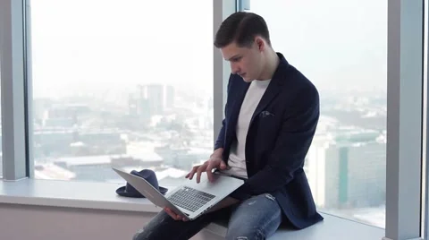 The young designer is considering a project on a laptop Stock Footage 59791078