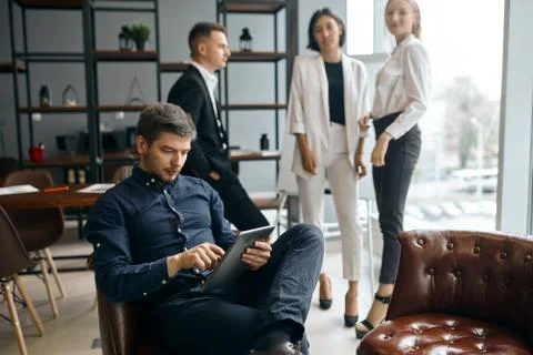 Young designer making up a project using gadget Stock-Fotos