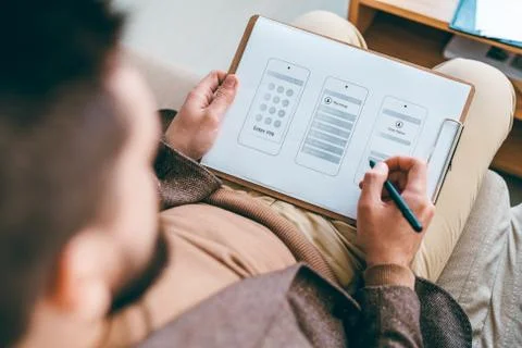 Young designer of software working over new ideas of smartphone interface Foto stock