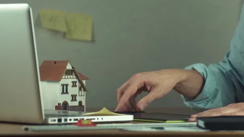 Young designer using sticky notes creating housing project on laptop Stock Footage 81880627