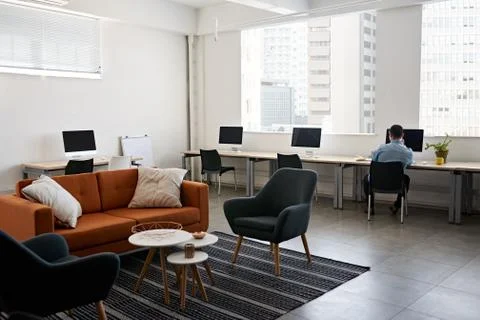 Young designer working alone in a modern office Stock Photos