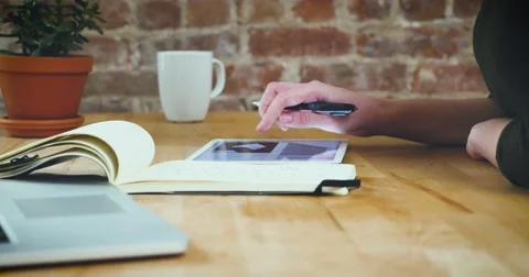 Young designer working on a creative project using the tablet Video stock 62240621