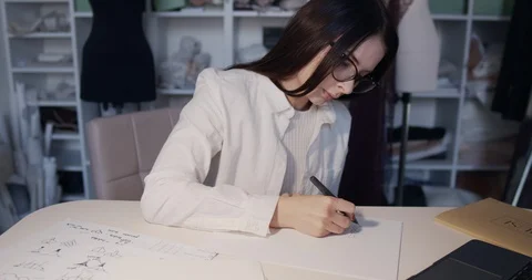 A young designer works at the computer in the workshop Stock Footage 129860045