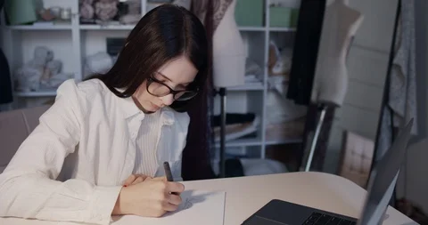 A young designer works at the computer in the workshop Stock Footage 129860146