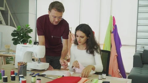Young designers are talking about designing clothes. Stock Footage 119217780