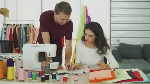 Young designers are talking about designing clothes in his clothing store. 動画素材 119217862