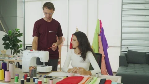 Young designers are talking about designing clothes. Stock Footage 121131255