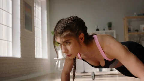 Young determined female athlete does push ups as part of cross fit training 스톡 동영상 128016937