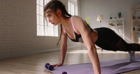 Young determined female athlete does push ups as part of cross fit training Video stock 133256347