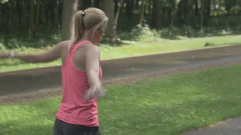 Young determined female doing jump exercises with skipping rope. Stockbeeldmateriaal 132612861