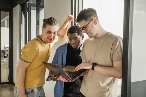 A young developer gives new project tasks to his partners. Business people are Stock Photos