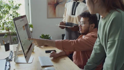 Young Developer Suggesting Solution to Bug in Code to Diverse Colleagues Stock Footage 293125367